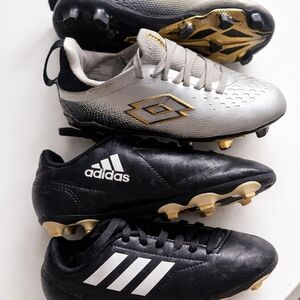 adidas Kids Black Soccer Cleats with White Stripes and Gold Accents